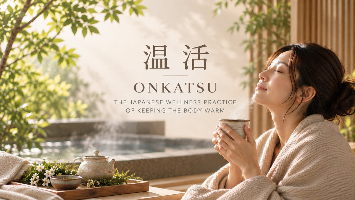 Onkatsu Japanese wellness practice with a woman enjoying a warm drink beside a hot bath in a peaceful natural setting.
